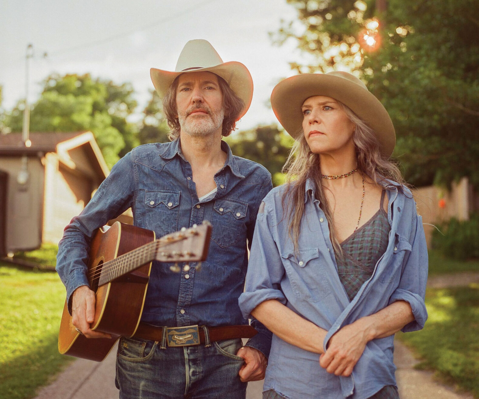 David Rawlings and Gillian Welch press photo artists stand on a path in the shade